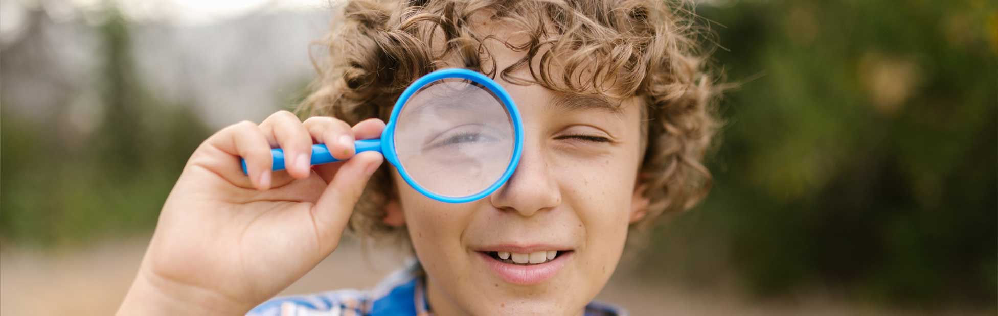 kid with magnifying glass