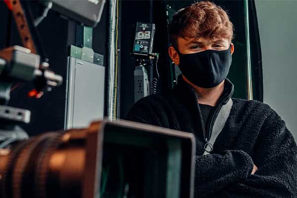 teenager in mask posing near camera