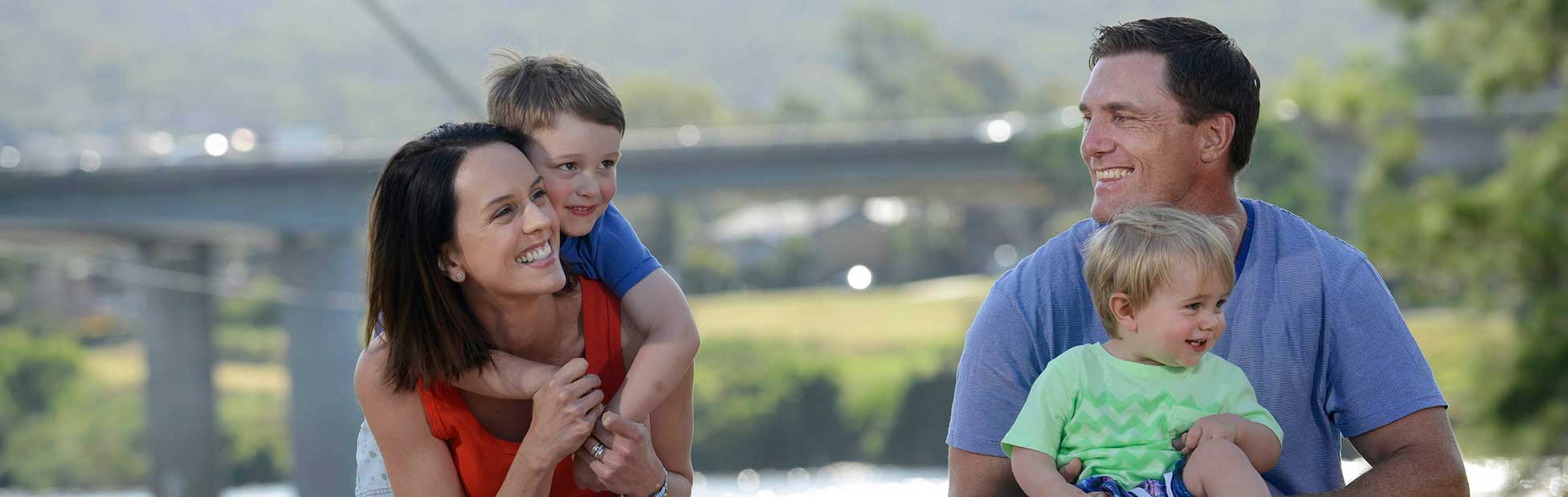 Family picnicing on banks of river