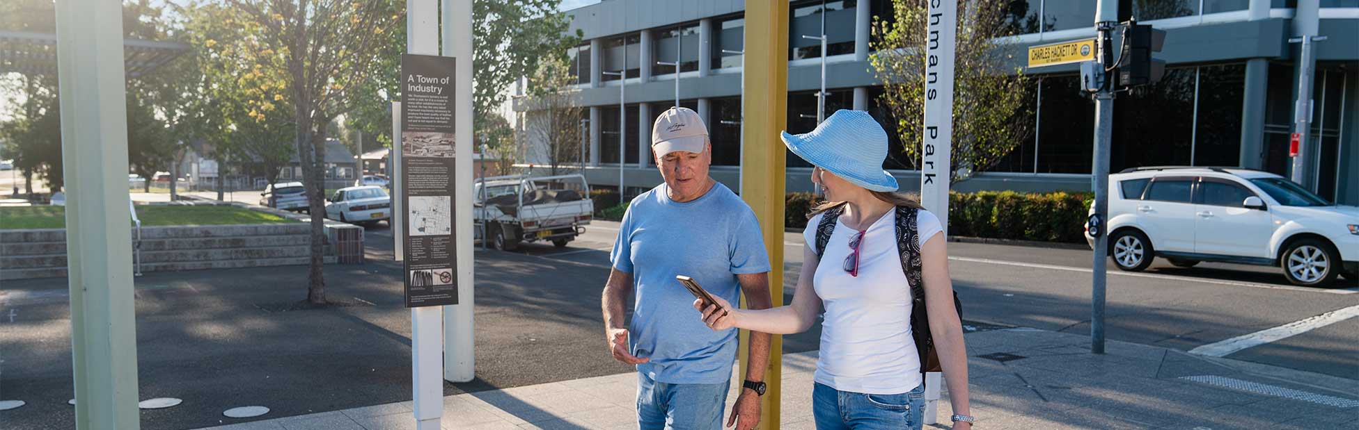 man and woman walking looking at map on phone