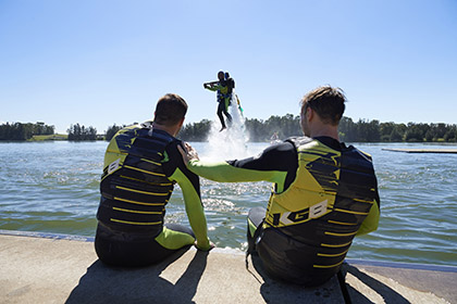 Two men watching another person rise out of the water with a jetpack on their back Jetpacking at the Regatta Centre