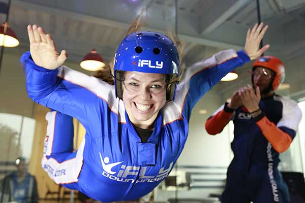 Young lady suspended in the air whilst indoor sky diving