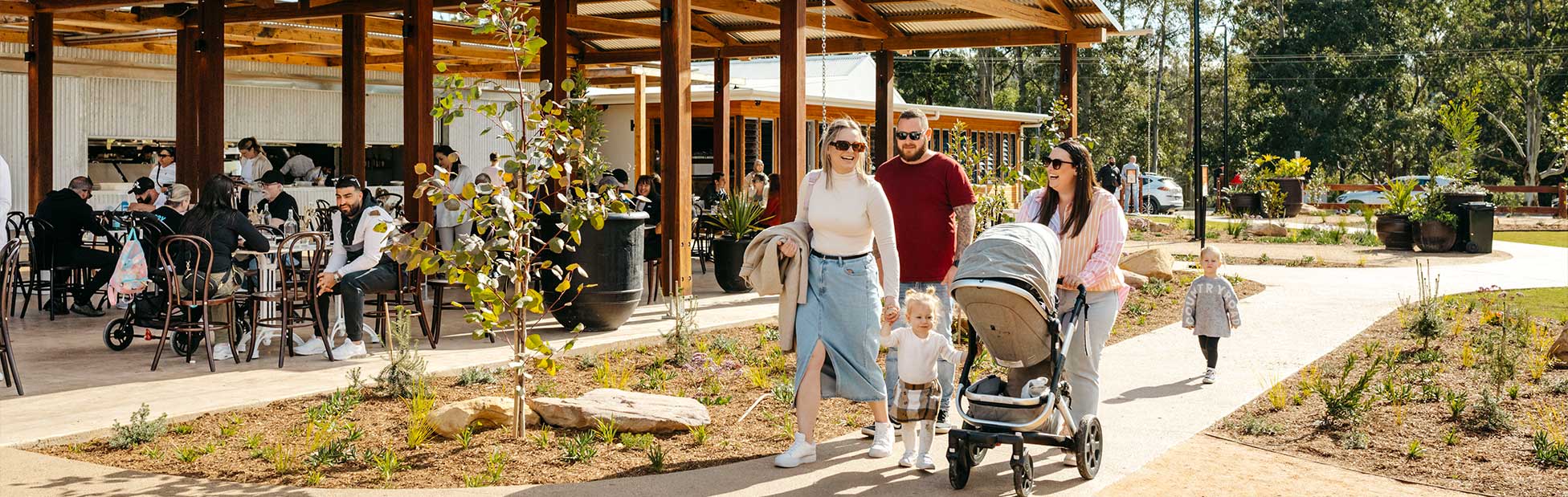 family walking with pram at orchard