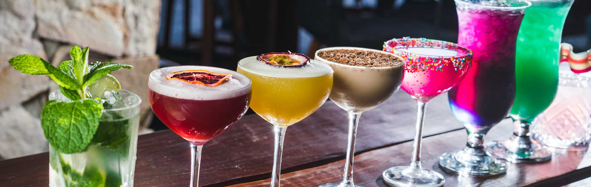 cocktails lined up on bar