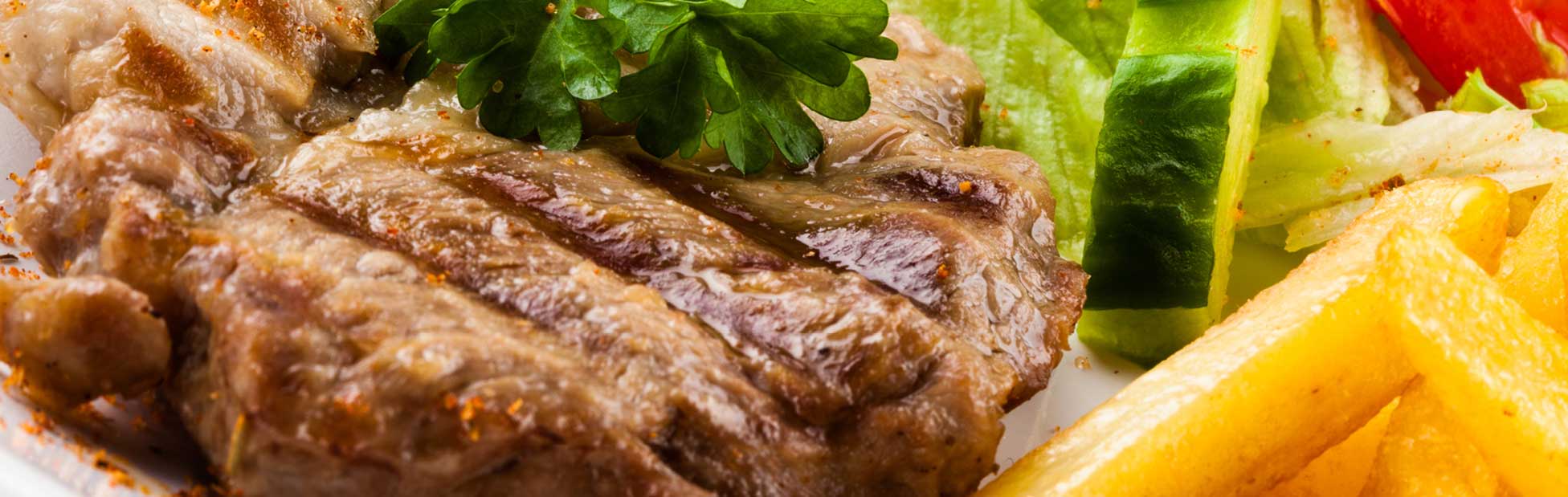 A steak with salad and chips on a plate