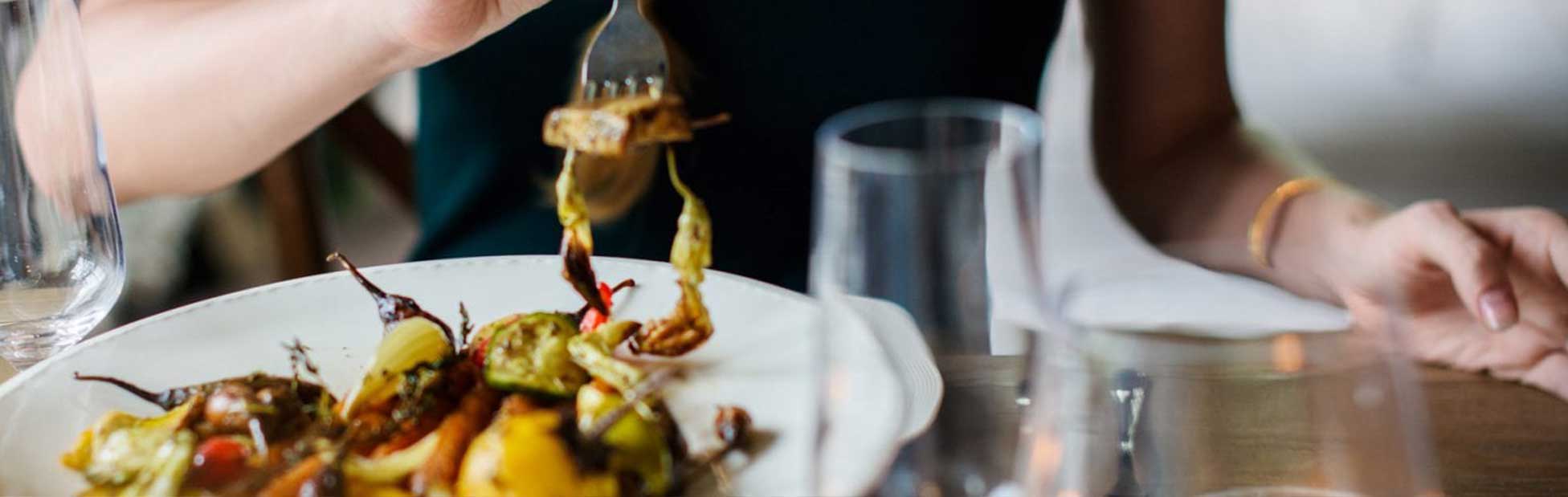 woman eating meal with fork