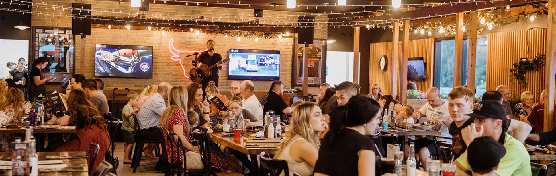 Performer on stage in busy restaurant