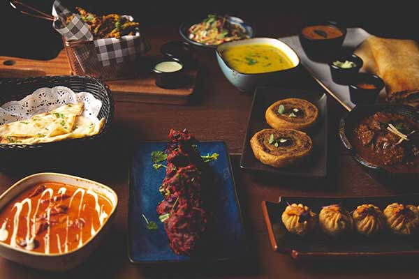 Various Indian dishes on wooden table
