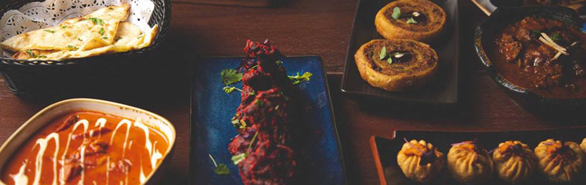 Various Indian dishes on wooden table