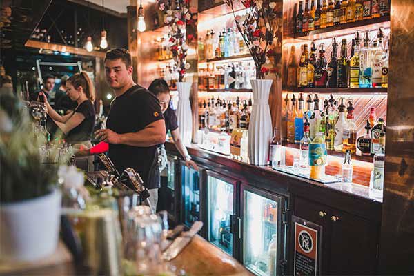 Bartenders serving and mixing drinks