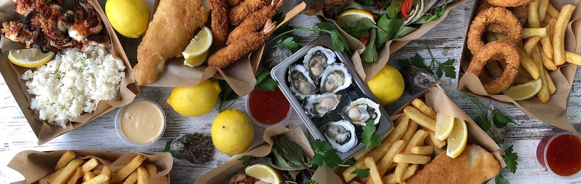 Spread of seafood including fish and chips