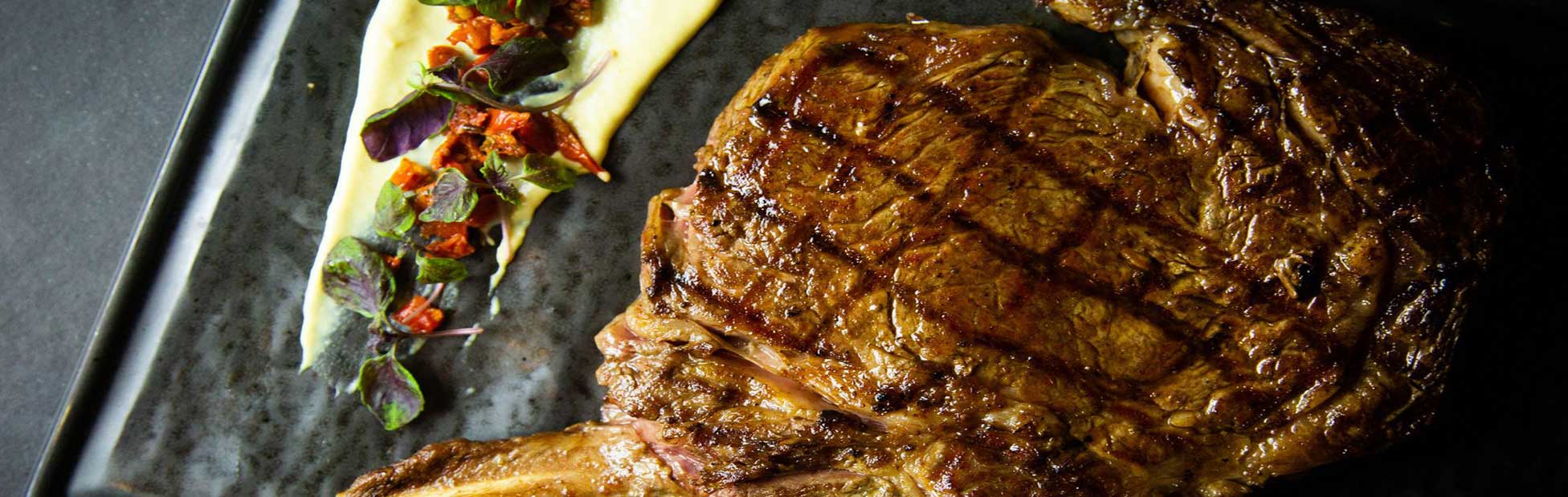 A rare cooked steak with potato mash on a plate