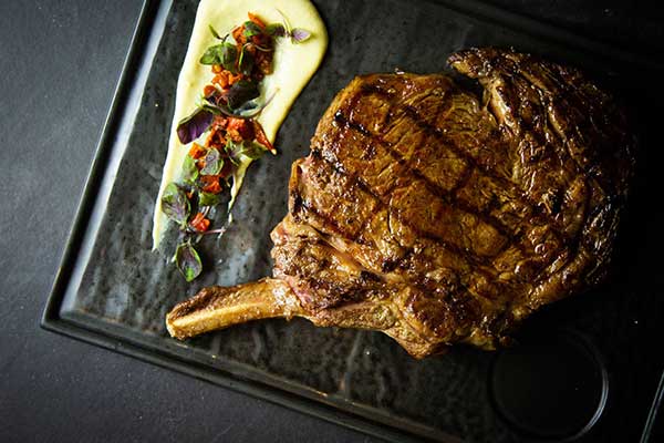 A rare cooked steak with potato mash on a plate