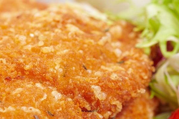 Chicken schnitzel with chips and salad on a plate