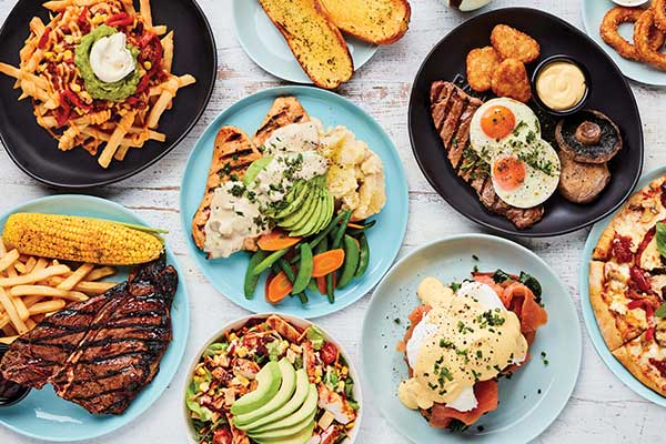 Table of plates with assortment of tasty looking food