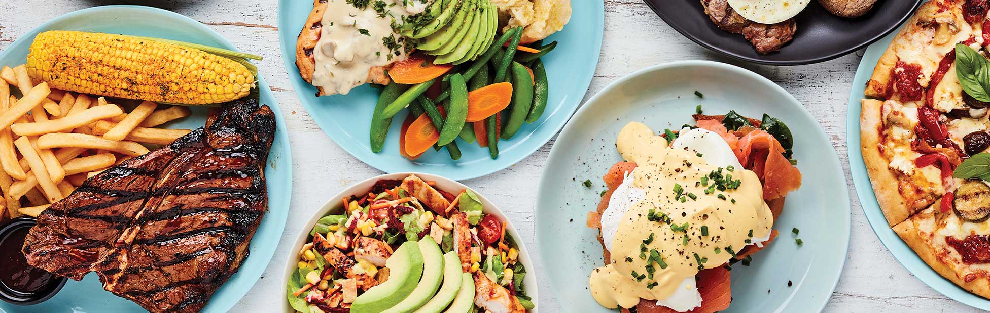 Table of plates with assortment of tasty looking food