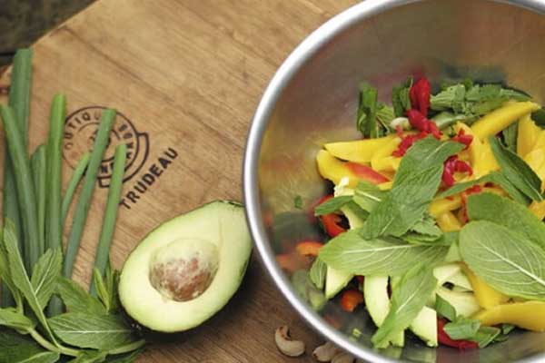 Fresh salad with avocado on board