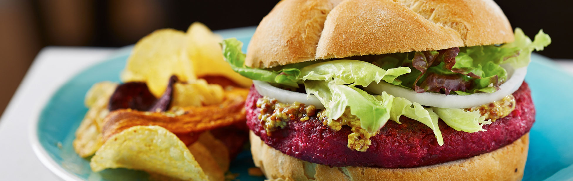 A gourmet burger with chips on a plate