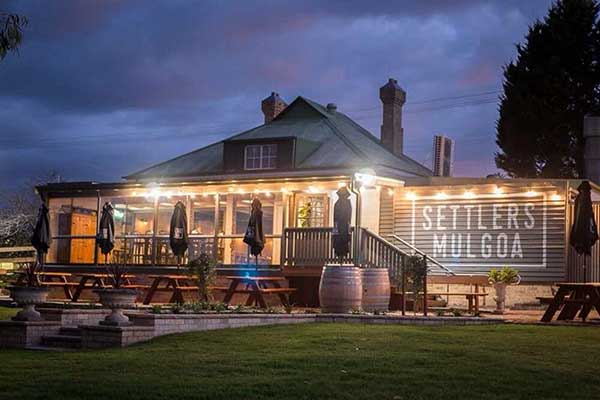 Rustic looking cafe building with sunset sky behind