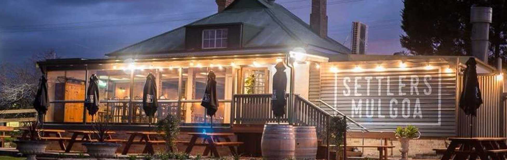 Rustic looking cafe building with sunset sky behind