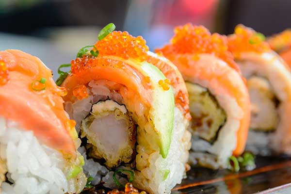 A close up of sushi with caviar served on a tray