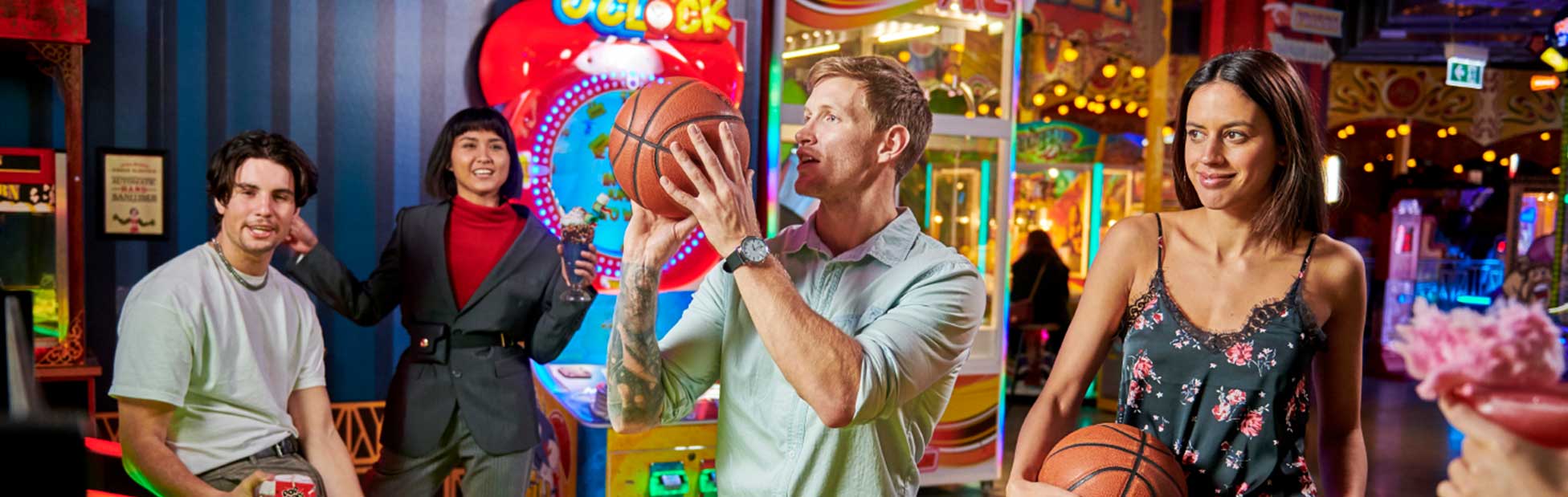 man in arcade shooting basketball