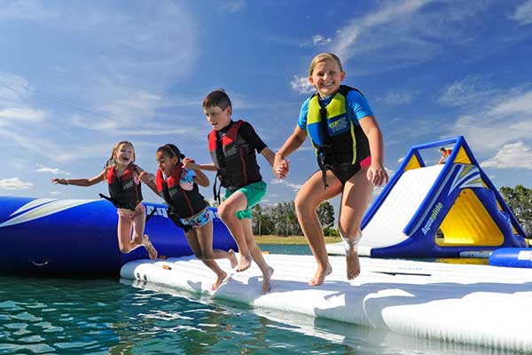 Group of children wearing water safety gear and having fun.