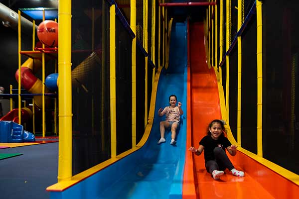 A side view of a large indoor kids playground.